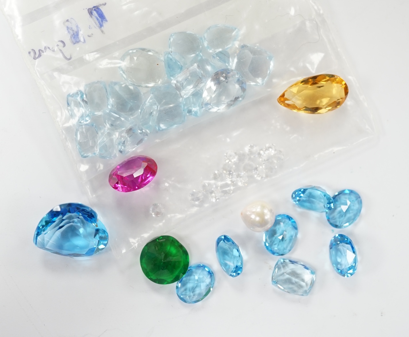 A small quantity of unmounted cut gemstones including diamonds and aquamarine. Fair condition.